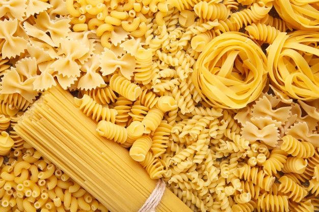 Various types of uncooked pasta arranged together.
